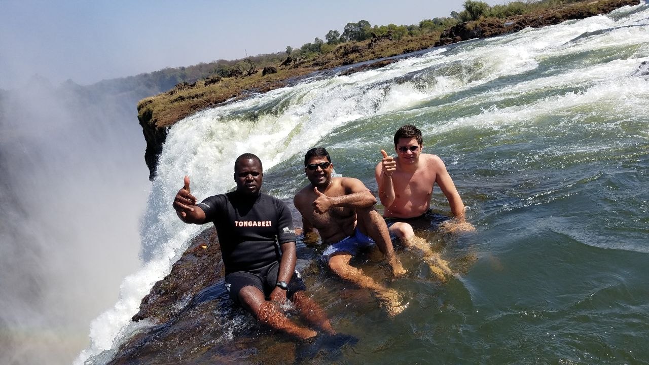 Robert Wallace and fellow travelers beside rushing water